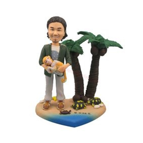 man on the beach with his pet bobble head doll