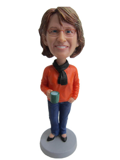 casuall female bobble head in sweater holding a cup
