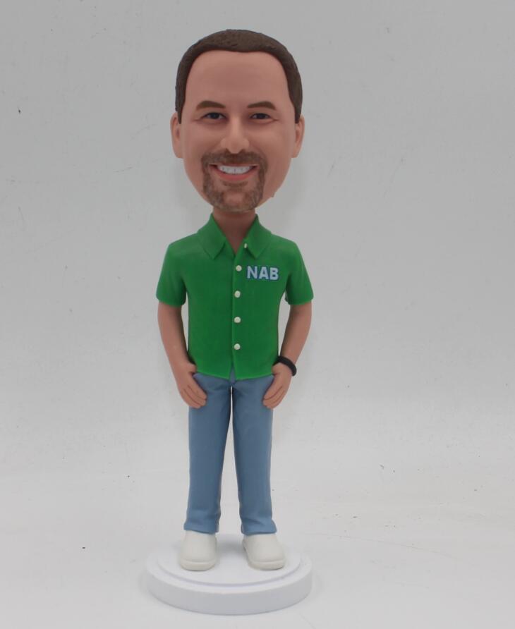 Man in green shirt with thumbs in Jeans pockets Bobble head doll