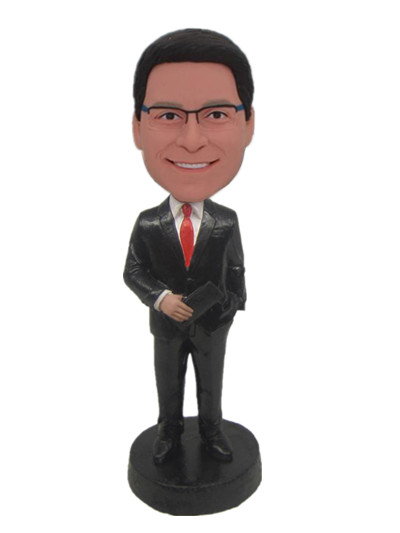 Groomsmen in black suit and red tie with a wallet bobbble head dolls