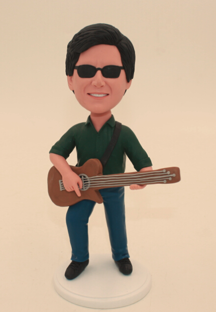 Man playing guitar bobble heads